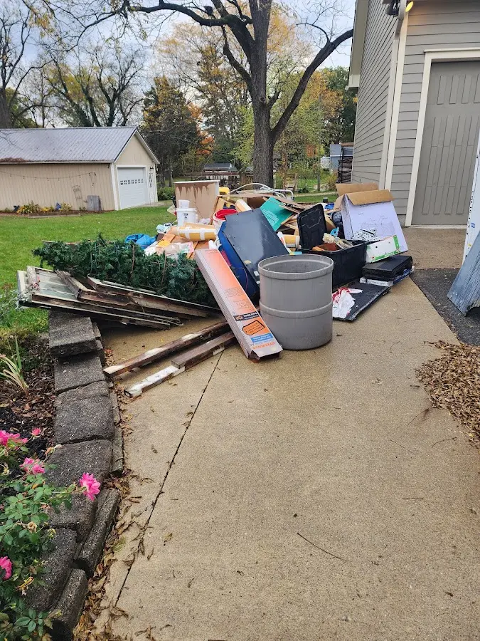 Dumpster being loaded with debris for 12 Yard Dumpster Rental in Grand Junction